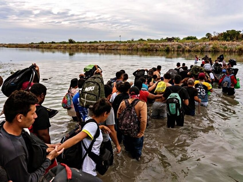 Migrants cross the Rio Grande at the US-Mexico border in Piedras Negras, Coahuila state, M