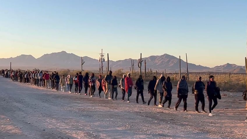 Migrants cross the US border in Arizona.