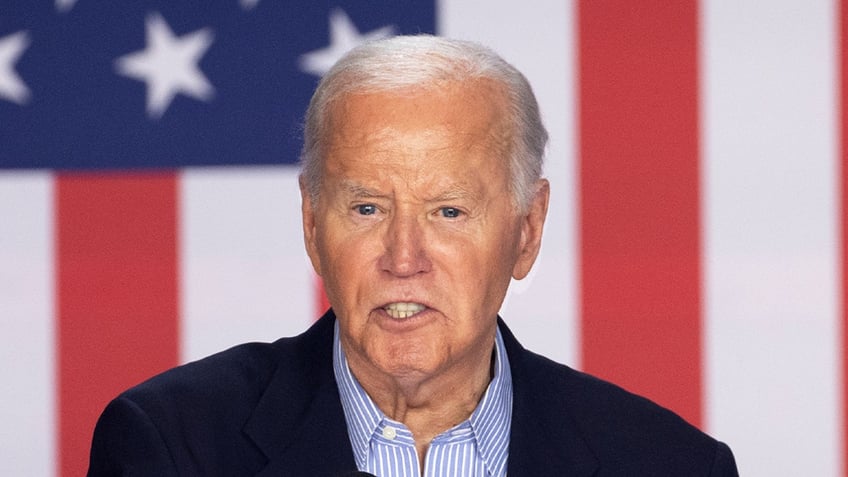 closeup shot of President Biden, US flag in background