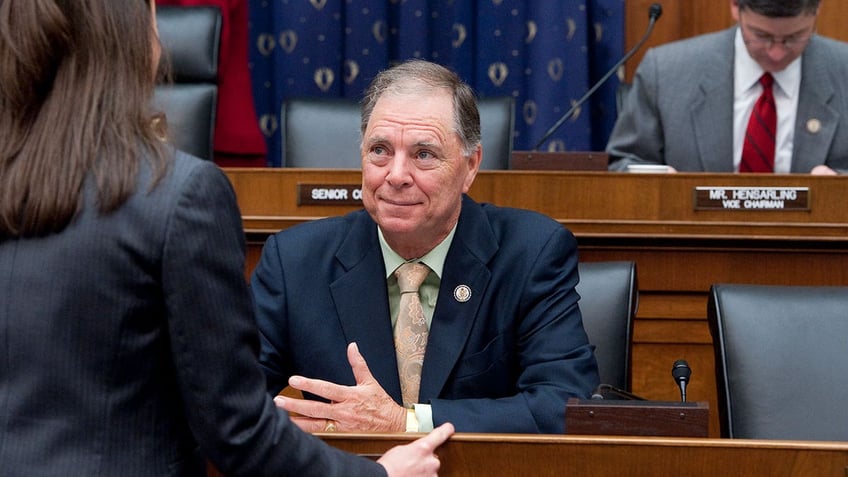 Rep. Bill Posey smiles while seated during hearing.