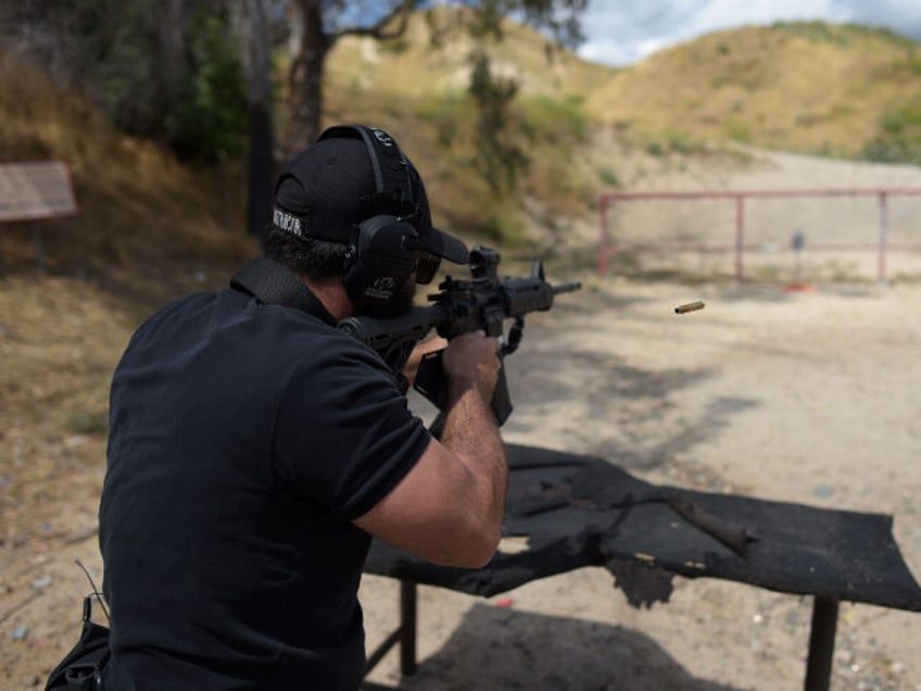 Rabbi Raziel Cohen, aka "Tactical Rabbi", shoots an AR-15 style semi-automatic r