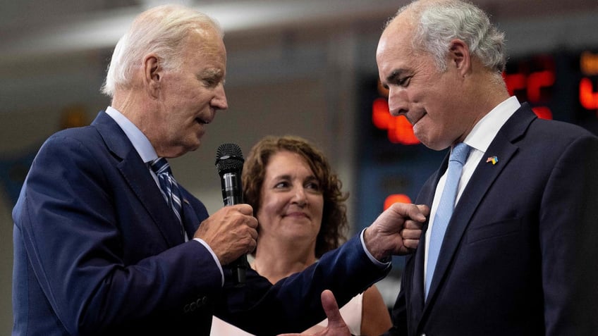 President Joe Biden greets Senator Bob Casey and his wife, Terese