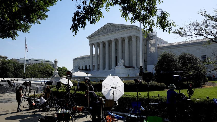 Journalists work outside of the U.S. Supreme Court Building in Washington, DC. (Photo by Anna Moneymaker/Getty Images)