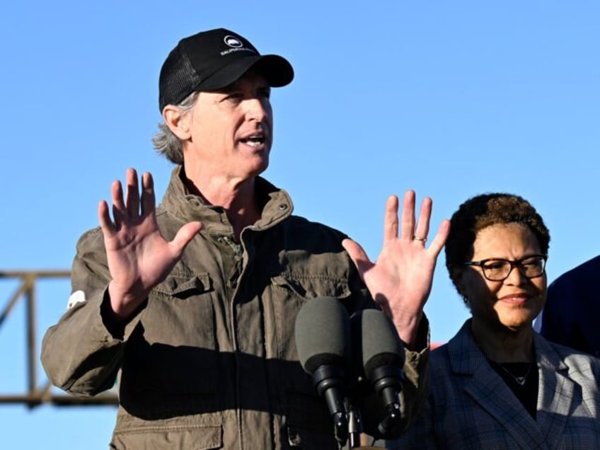 California Gov. Gavin Newsom, center, speaks alongside Vice President Kamala Harris, left,