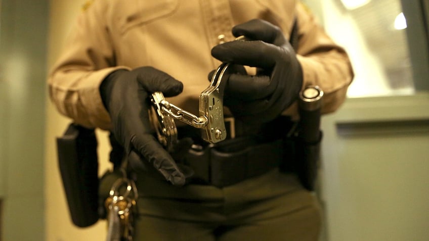 California prison officer holds handcuffs