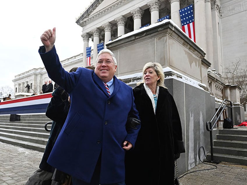 West Virginia Governor Patrick Morrisey and his wife, Denise, greet people following his s