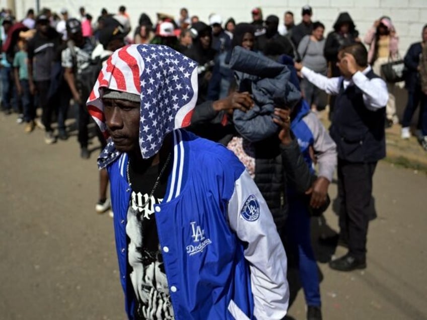 A migrant waits outside the facilities of the Commission for Refugee Assistance (COMAR) to