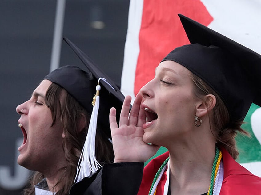 Protesters wearing graduation caps and gowns join other demonstrators outside the Huntsman