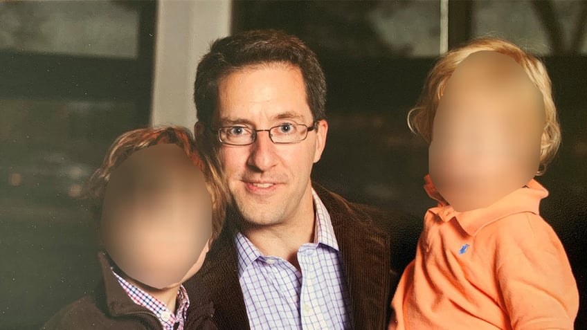 Dan Markel smiling with kid