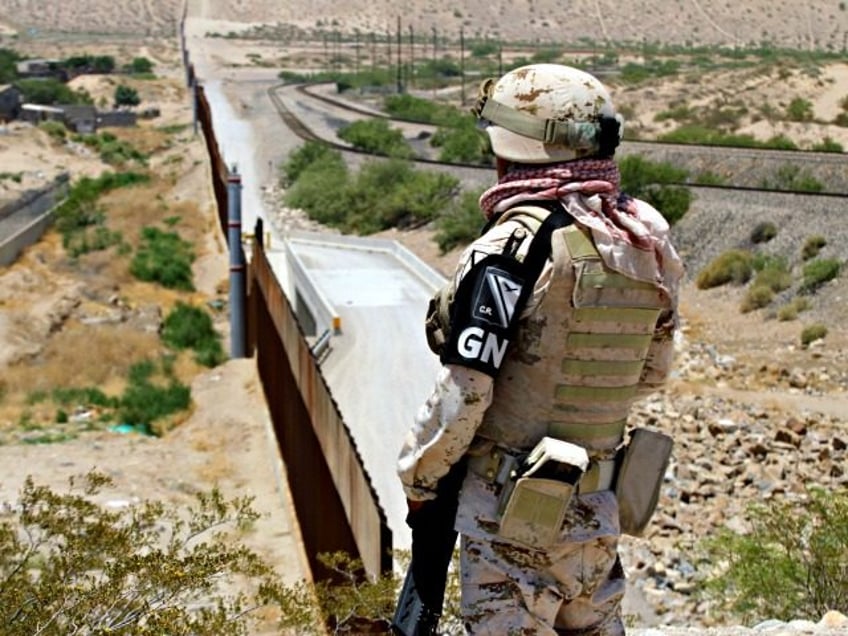 A member of Mexican National Guard watches the border with the US at the Anapra area in Ci