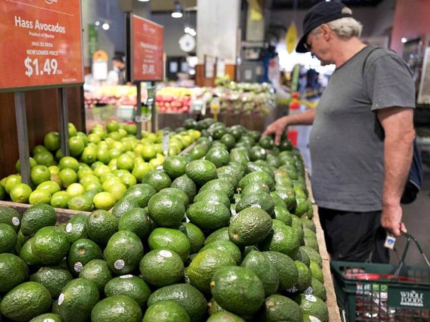 A man shops for avocados at a Whole Foods Market, Monday, Aug. 28, 2017, in New York. Amazon is moving swiftly to make big changes at Whole Foods, saying it plans to cut prices on avocados, bananas, eggs, salmon, beef and more. Amazon has completed its $13.7 billion takeover of …