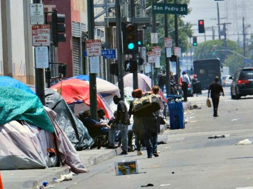In this May 30, 2019 file photo, tents housing homeless line a street in downtown Los Ange