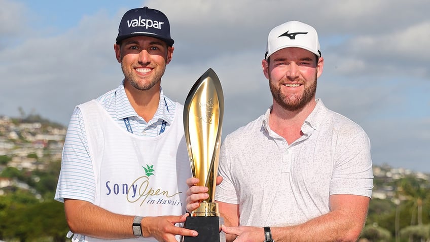 Jay Green and Grayson Murray hold trophy