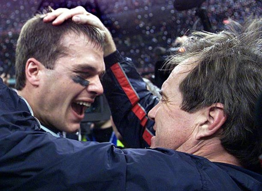 New England Patriots' quarterback Tom Brady celebrates with head coach Bill Belichick after their win over the St. Louis Rams 03 February, 2002 in...