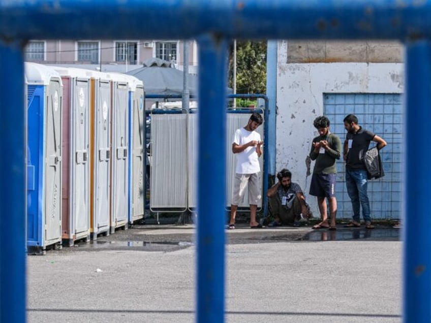 KALAMATA, GREECE - JUNE 15: A few of the surviving migrants brush their teeth shower and g