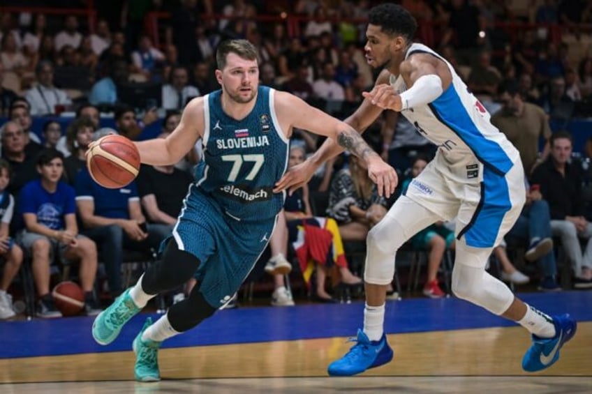 Slovenia’s Luka Doncic (L) is marked by Greece’s Giannis Antentokoumpo during the 2024