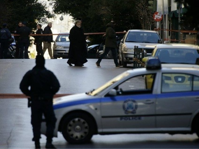 A Greek Orthodox priest arrives after an explosion at the Orthodox church of Agios Dionysi