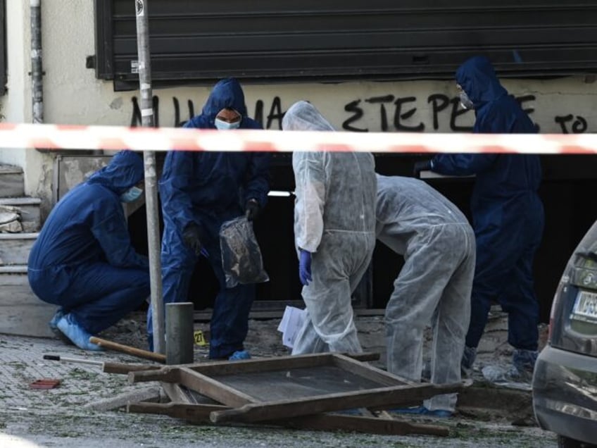 Greek police experts search for evidence after a bomb explosion in Thessaloniki on May 3,