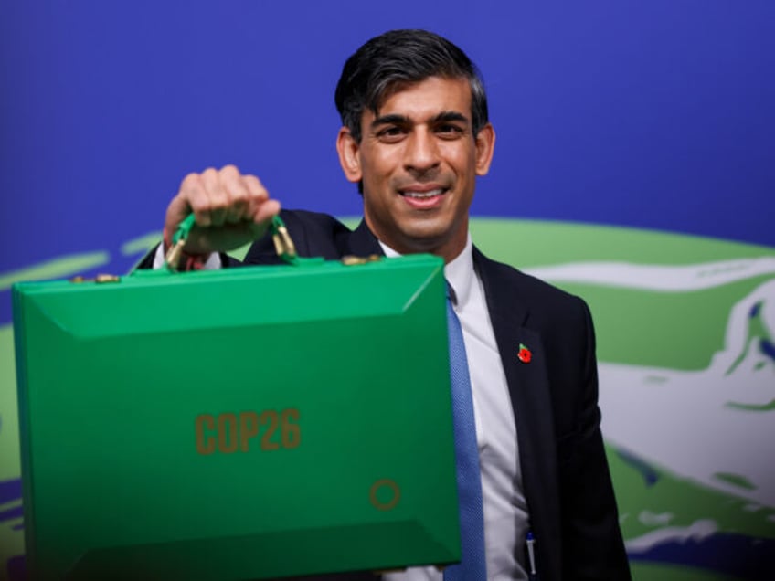 Rishi Sunak, U.K. chancellor of the exchequer, holds a COP26 Green despatch box during the