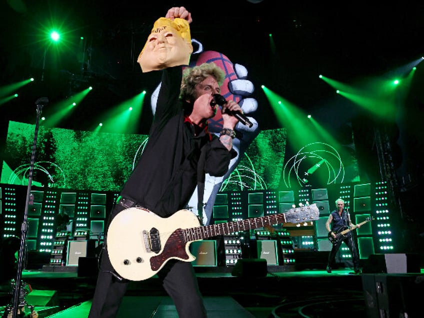 WASHINGTON, DC - JULY 29: Billie Joe Armstrong of Green Day holds a Donald Trump mask whil