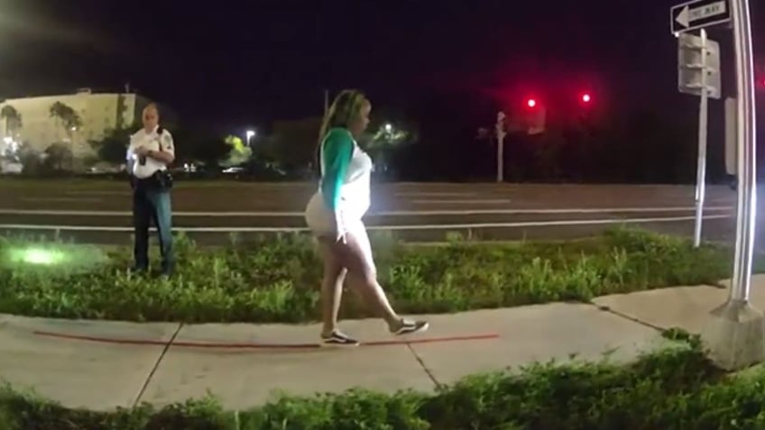 Woman does walk and turn sobriety test.