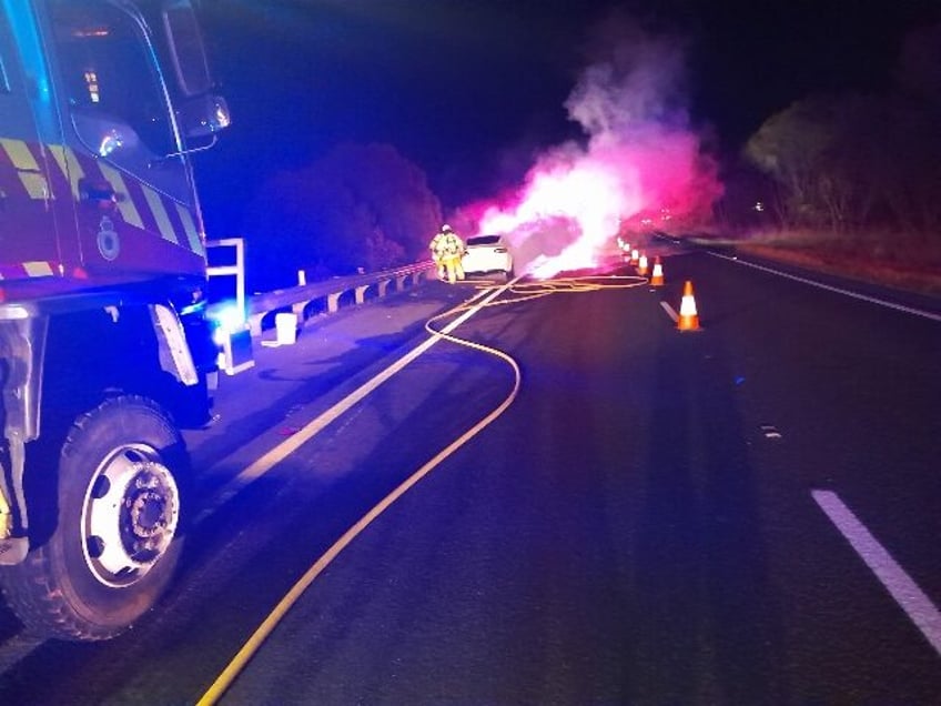 green inferno tesla bursts in flames on busy australian highway