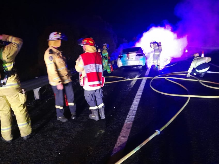 green inferno tesla bursts in flames on busy australian highway