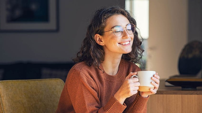 Woman smiling with hot drink