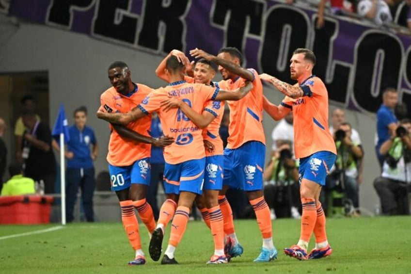 Mason Greenwood is mobbed by his teammates after scoring for Marseille against Toulouse