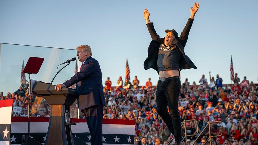 Tesla CEO Elon Musk jumps on stage as he joins former US President and Republican presidential candidate Donald Trump during a campaign rally at site of his first assassination attempt in Butler