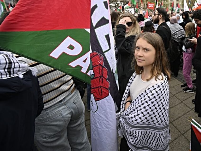 Swedish climate activist Greta Thunberg (C) attends a rally in Malmo, Sweden, in protest a