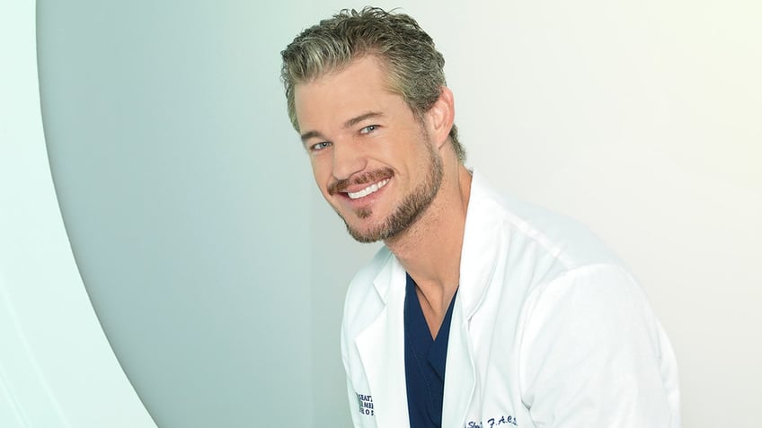 Eric Dane as Dr. Mark Sloan on "Greys Anatomy" wearing a white coat and dark blue scrubs