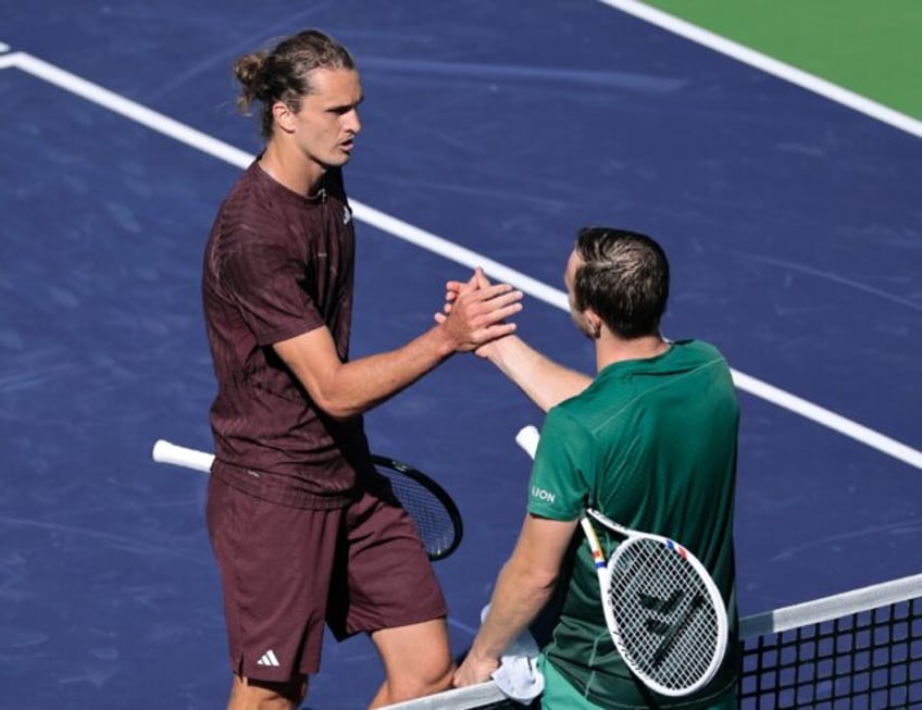 Top-seeded Alexander Zverev of Germany shakes hands with Tallon Griekspoor after falling t