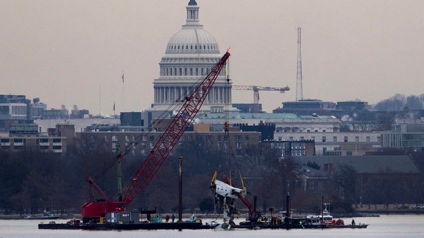 Wreckage from American Airlines flight 5342 is pulled from the Potomac River