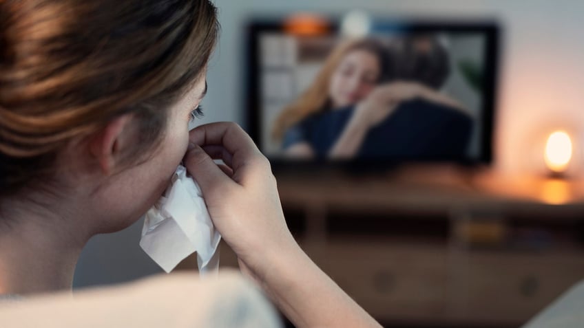 Woman sad watching TV