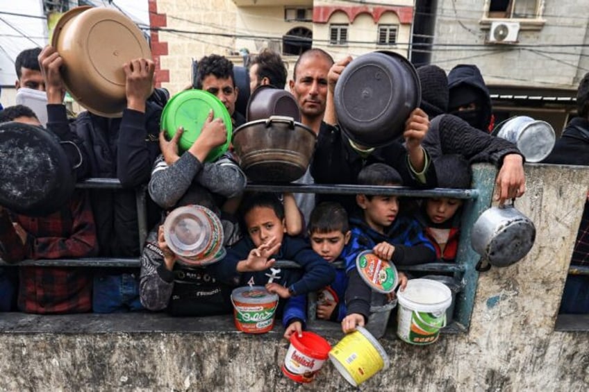 Many children are among those queueing, desparate for food