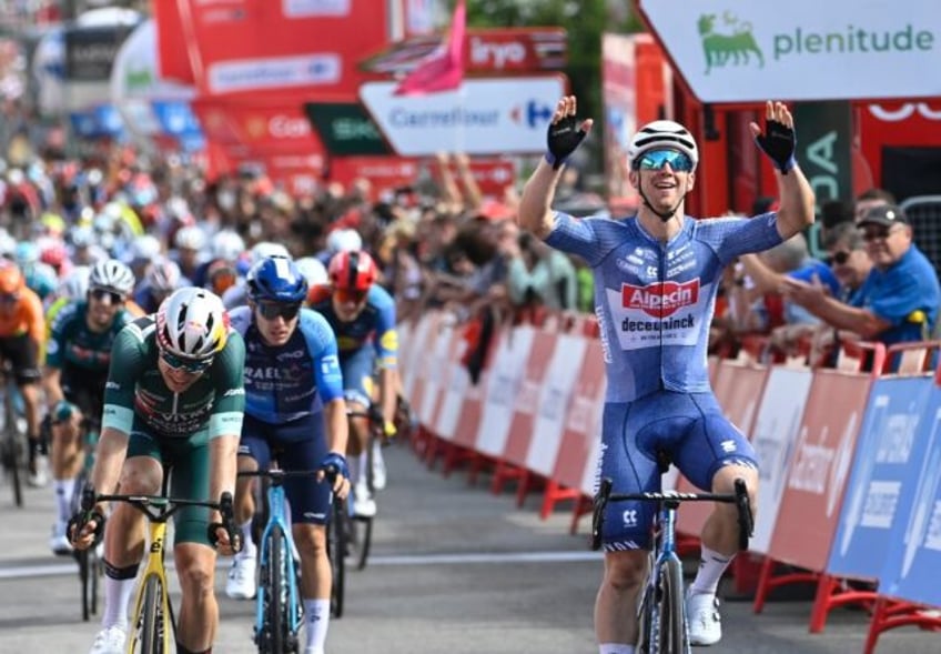 Kaden Groves (R) crosses the line ahead of Wout van Aert to win stage 14 of the Vuelta a E