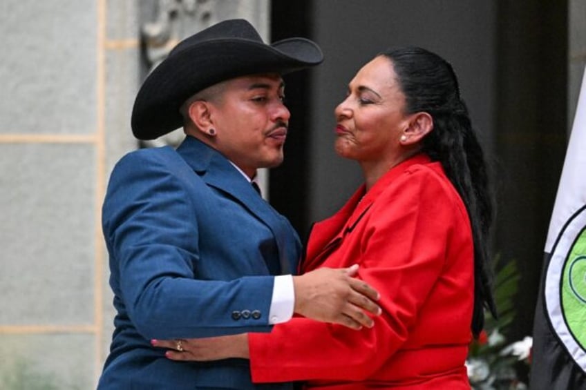 Osmin Tobar hugs his mother Flor Ramirez during a ceremony at which Guatemalan President B