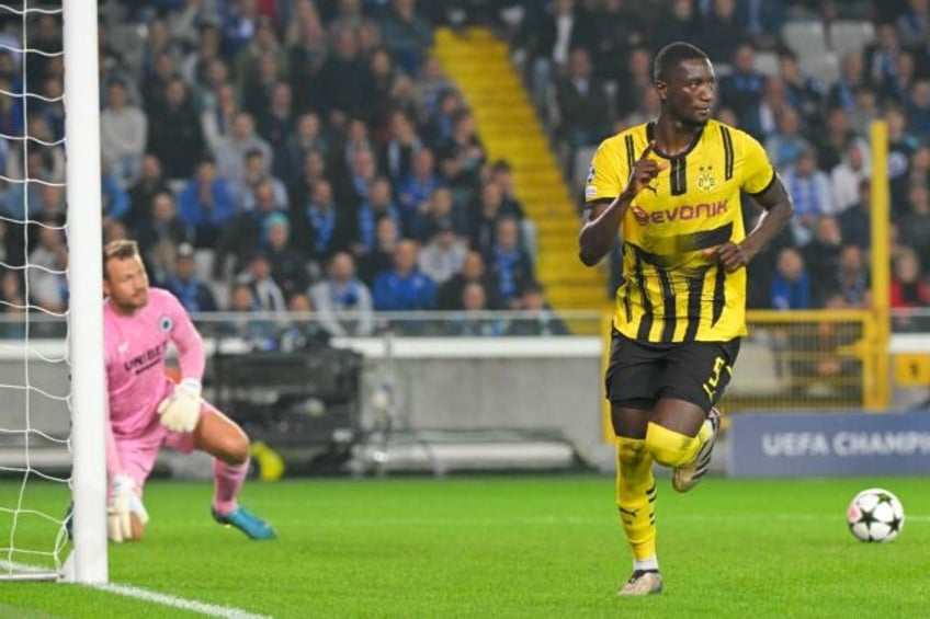 Borussia Dortmund forward Serhou Guirassy (R) scored a penalty after coming off the bench