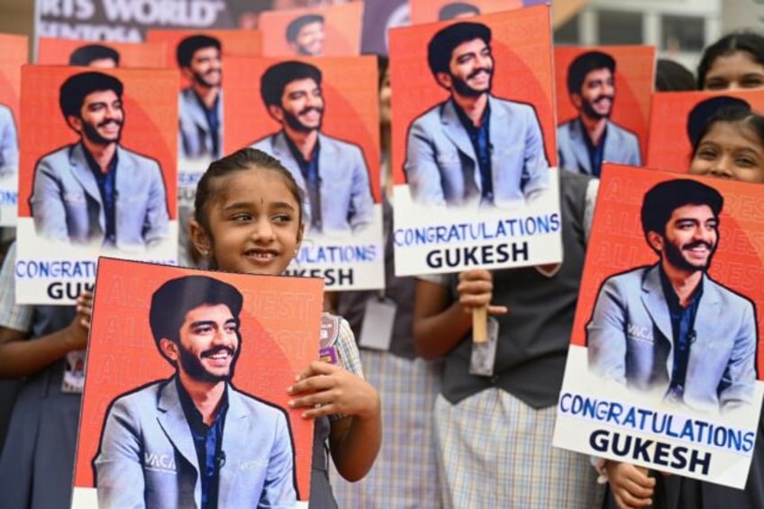 Indian school students congratulate the world's youngest chess champion Gukesh Dommaraju,