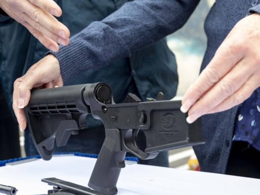 A bump stock and handguns collected during a buyback event in the Wilmington neighborhood