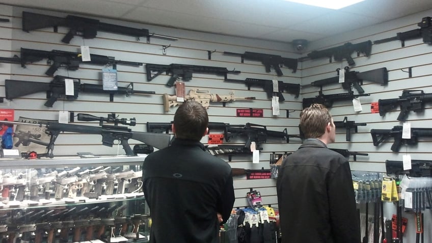 Customers view guns in a Los Angeles gun shop