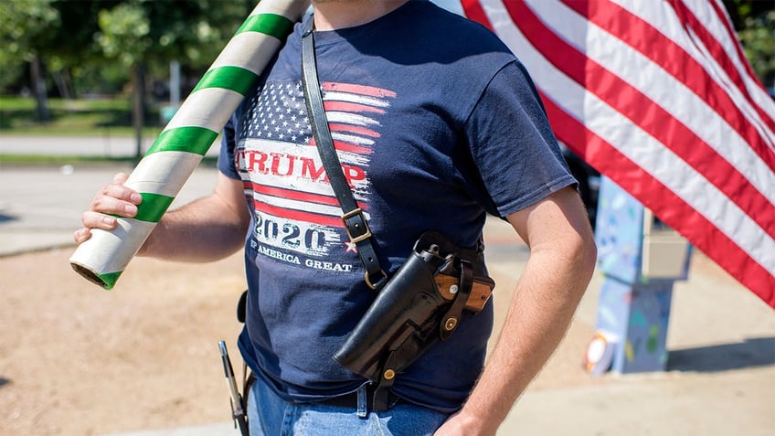 A man open carries a pistol in Texas.