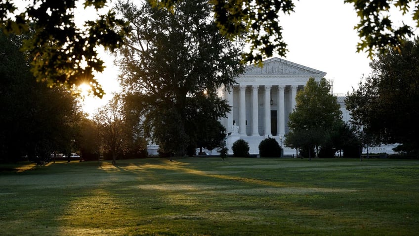 Supreme Court seen in the morning, sun behind building