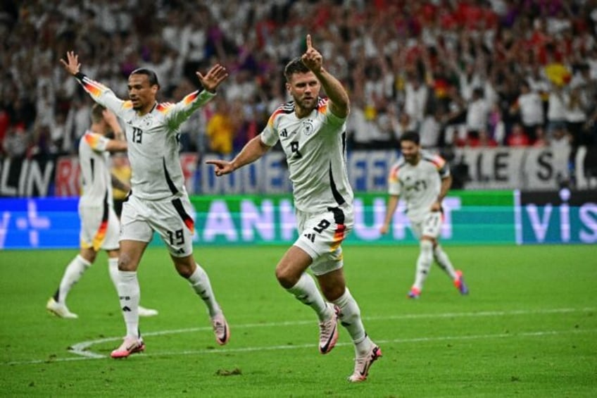 Niclas Fuellkrug and his Germany team-mates celebrate his last-gasp equaliser against Swit