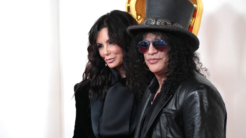 Meegan Hodges and Slash posing on the red carpet