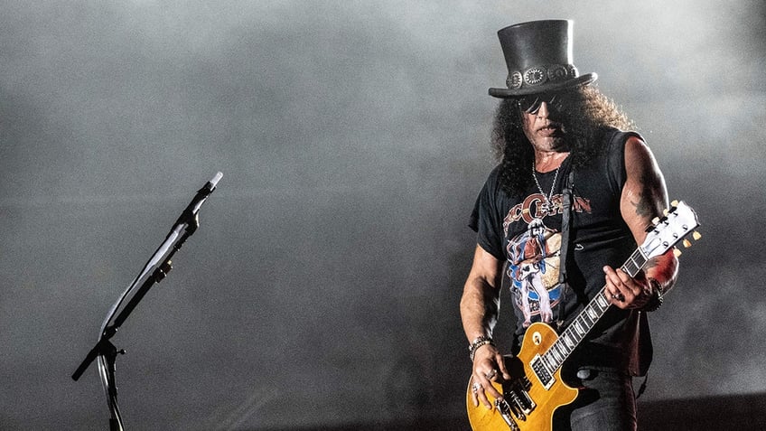 Slash playing guitar on stage