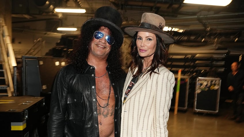 Slash and partner Meegan Hodges posing backstage