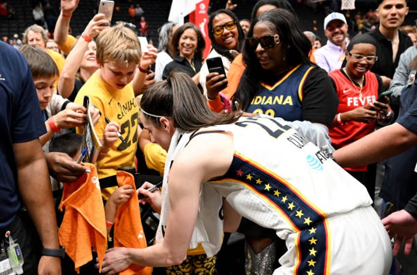Caitlin Clark of the Indiana Fever signs autographs after the game against the Washington Mystics at Capital One Arena on June 07, 2024 in...