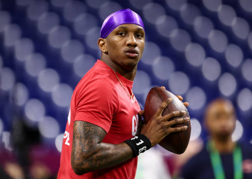 Michael Penix #QB08 of Washington participates in a drill during the NFL Combine at the Lucas Oil Stadium on March 2, 2024 in Indianapolis, Indiana.